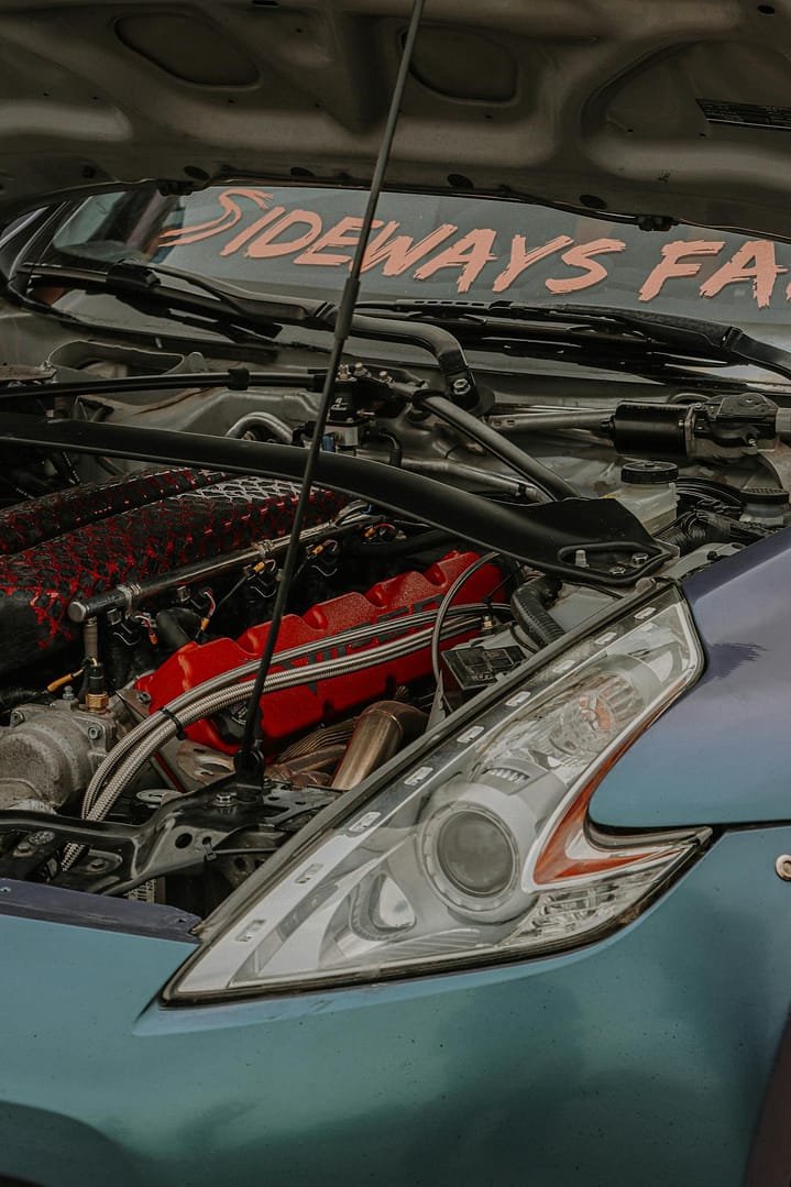Detailed close-up of a modern car engine showcasing intricate design elements and shiny components.